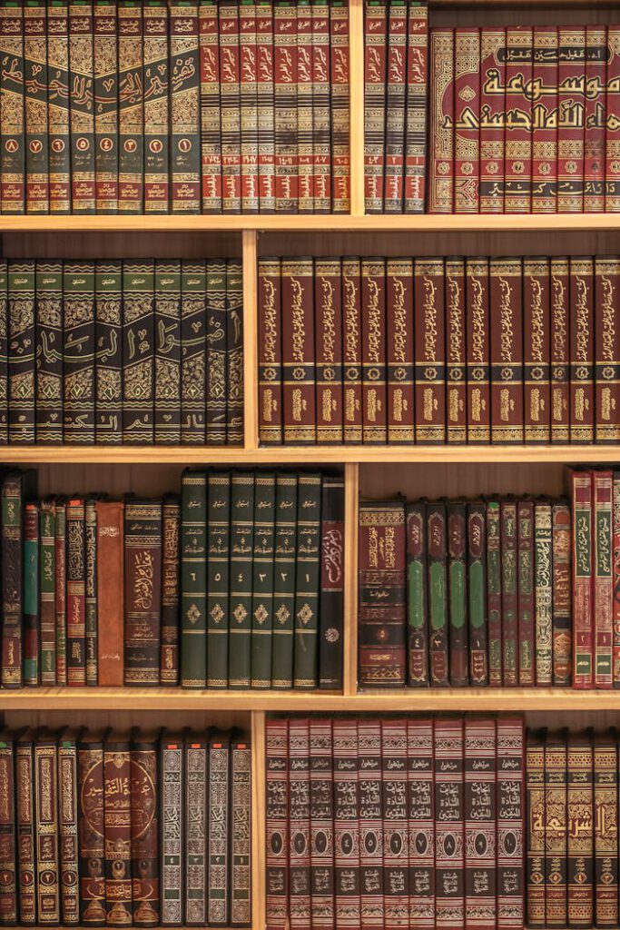 A collection of Islamic books neatly arranged on wooden shelves showcasing rich cultural heritage.